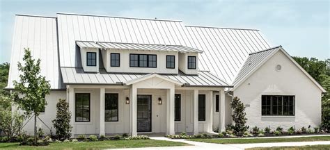 metal roof on brick house with white doors and windows|pictures of brick house roofs.